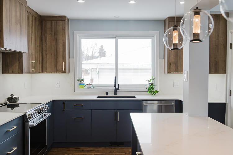 Full-Kitchen-View-With-Blue-Lower-Cabinets-And-Globe-Pendant-Lights Kitchen Renovation by Atom Builder
