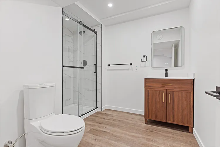 insurance-flood-restoration-06-rebuilt-basement-bathroom-glass-shower